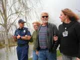 Firefighter and Nurse walking with two senior citizens