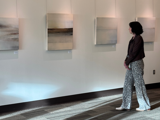 Photo of someone in a gallery looking at artwork.